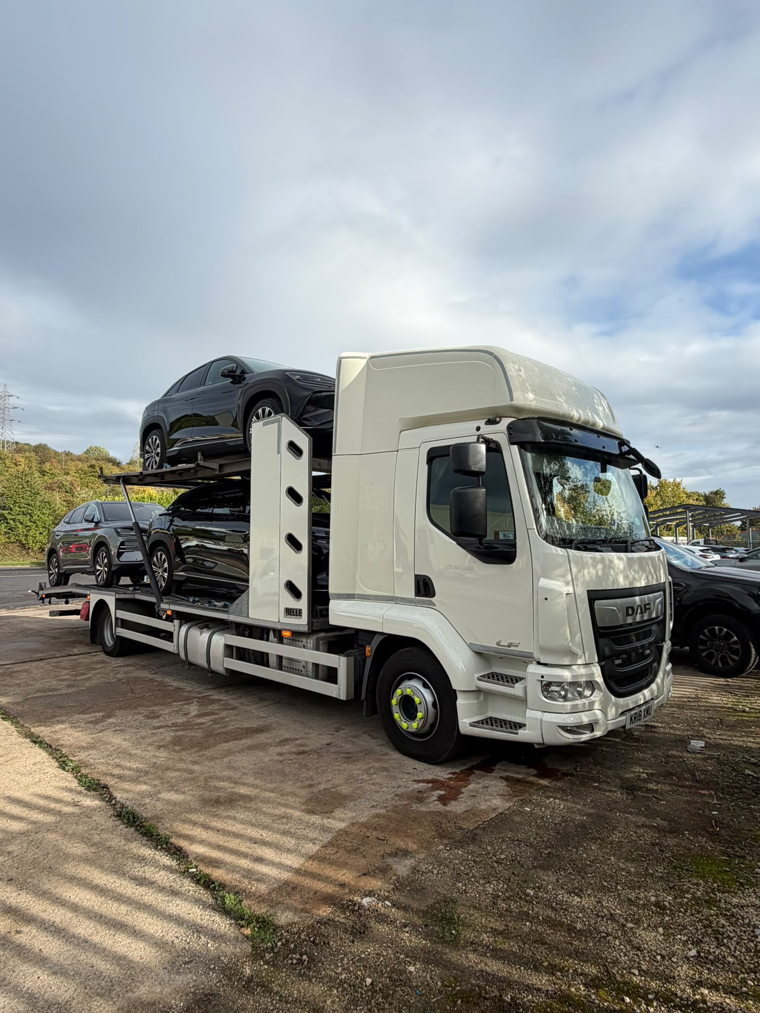 DAF two-deck open transporter carrying three SUVs