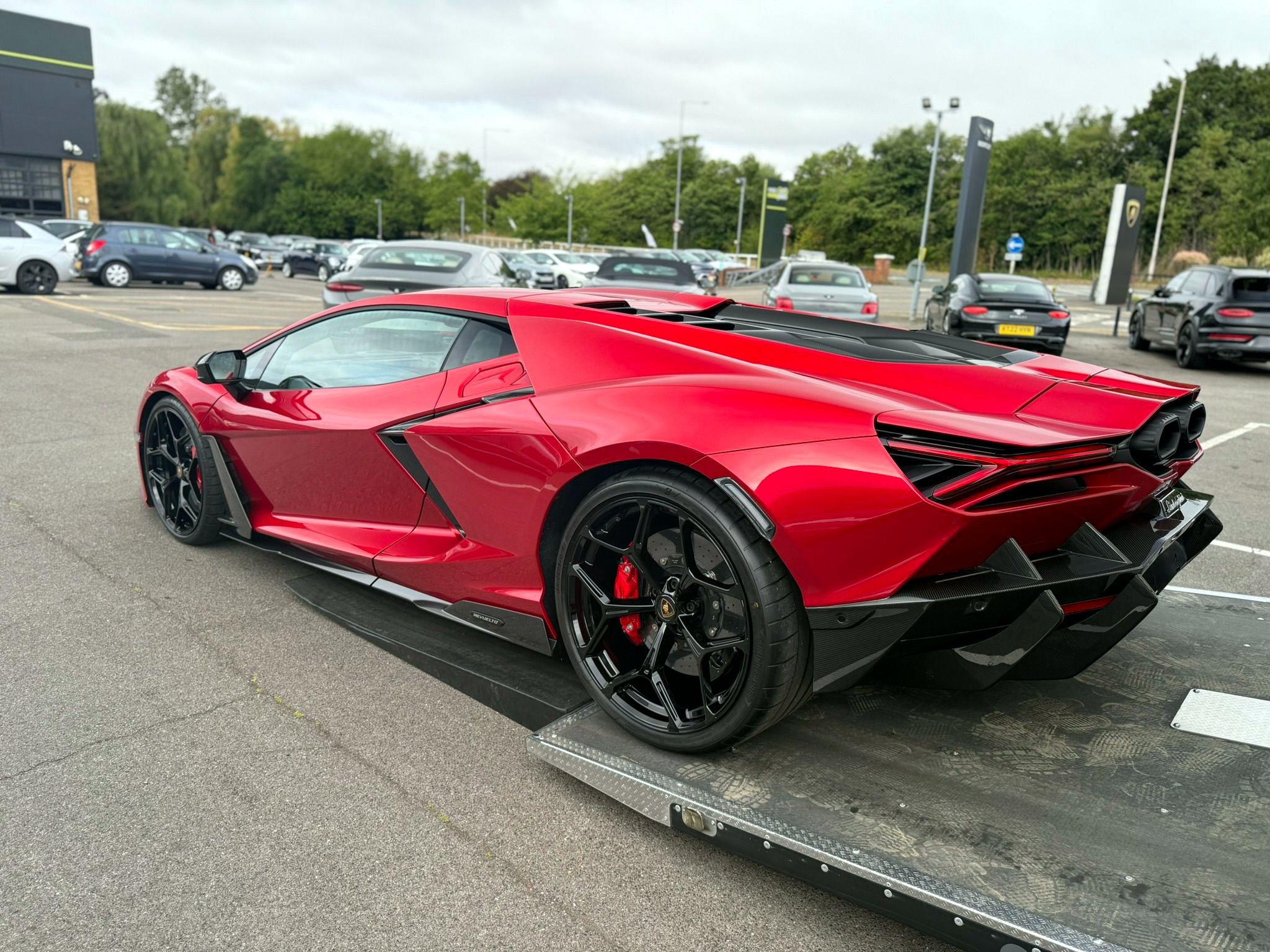 Red Lamborghini Revuelto being collected onto the DMT transporter