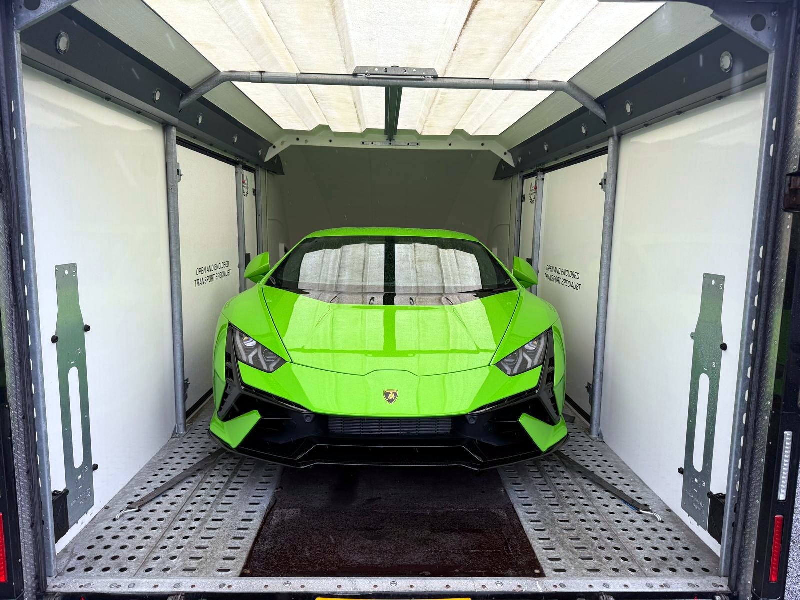 Green Lamborghini Huracán secured inside the DMT enclosed trailer